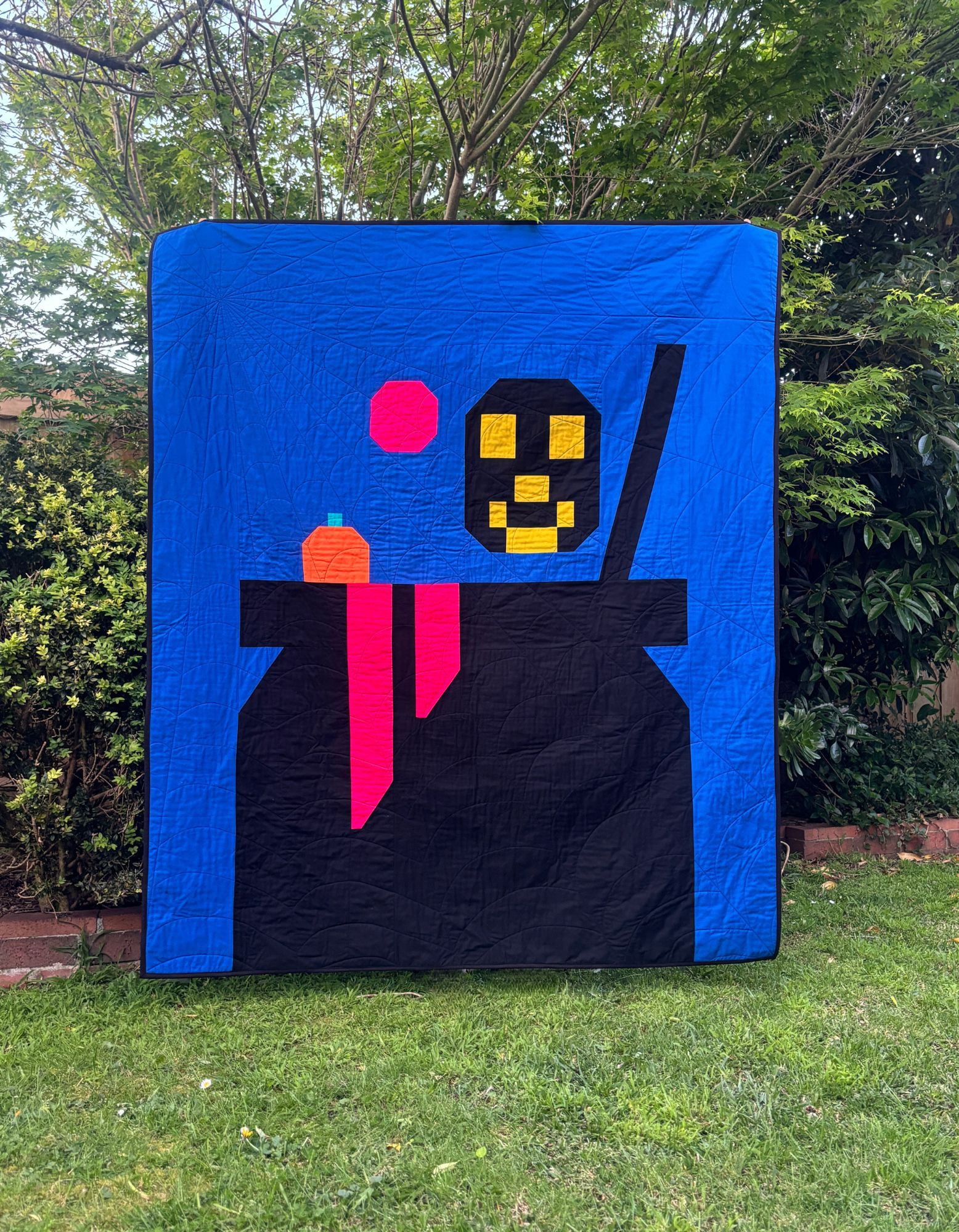 Halloween cauldron quilt with skull and pumpkin portions