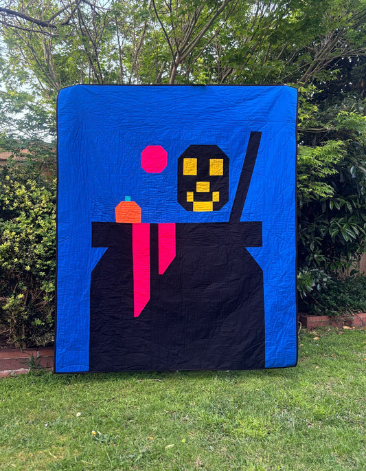 Halloween cauldron quilt with skull and pumpkin portions