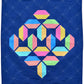 Flourishing quilt pattern in scrappy colours pink, peach, yellow, blue, green and lime on a navy blue background