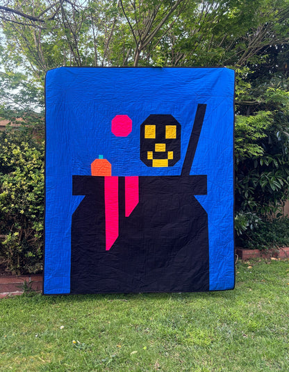 Halloween cauldron quilt with skull and pumpkin portions
