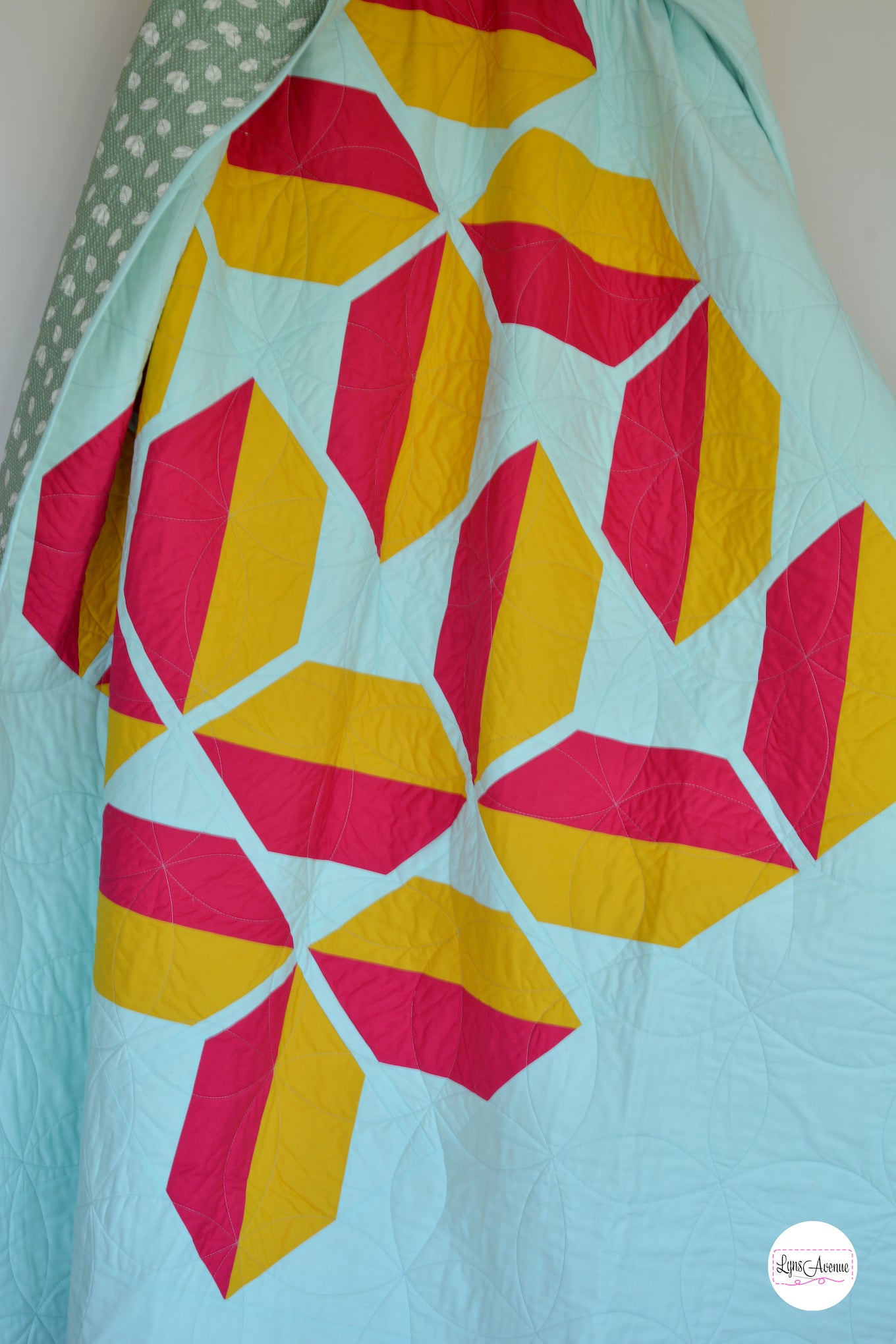 Flourishing quilt in two colour version of red and yellow on a light green background